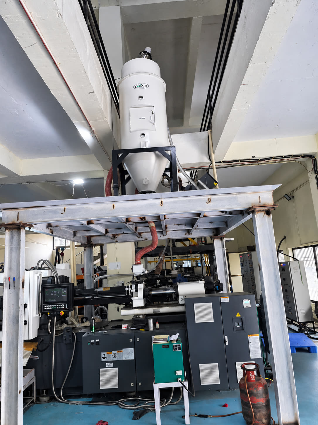 Resin drying hopper above the molding machine